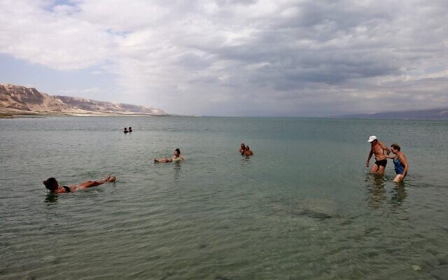People take a dip in the Dead Sea near the Mitzpe Shalem settlement in the West Bank, on September 24, 2021. (Menahem KAHANA / AFP) People take a dip in the Dead Sea near the Mitzpe Shalem settlement in the West Bank, on September 24, 2021. (Menahem KAHANA / AFP)