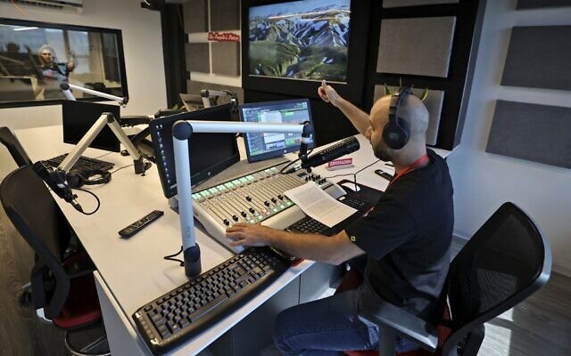 Employees work at the newly launched Jerusalem 24 radio station in Ramallah on October 7, 2021. (Abbas Momani / AFP) Employees work at the newly launched Jerusalem 24 radio station in Ramallah on October 7, 2021. (Abbas Momani / AFP)