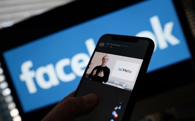 In this illustration photo taken in Los Angeles on October 28, 2021, a person watches on a smartphone as Facebook CEO Mark Zuckerberg unveils the Meta logo. (Chris Delmas/AFP) In this illustration photo taken in Los Angeles on October 28, 2021, a person watches on a smartphone as Facebook CEO Mark Zuckerberg unveils the Meta logo. (Chris Delmas/AFP)
