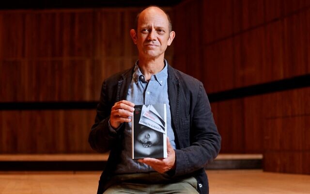 South African author Damon Galgut poses with his book 'The Promise' on October 31, 2021. (Tolga Akmen / AFP) South African author Damon Galgut poses with his book 'The Promise' on October 31, 2021. (Tolga Akmen / AFP)