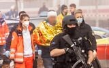 German police and rescue workers walk with a detained man, on November 6, 2021, in Seubersdorf, southern Germany, after several people were wounded in a knife attack on a high-speed train. (Fabian Schreiner/dpa/AFP)