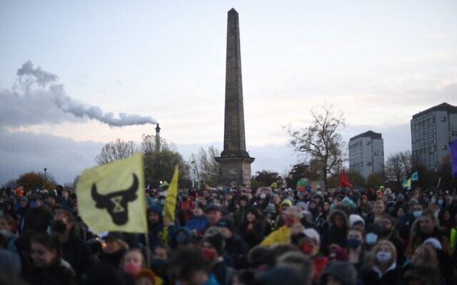 People participate in a protest rally during a global day of action on climate change in Glasgow, on November 6, 2021, during the COP26 UN Climate Change Conference. (Daniel Leal-Olivas/AFP)