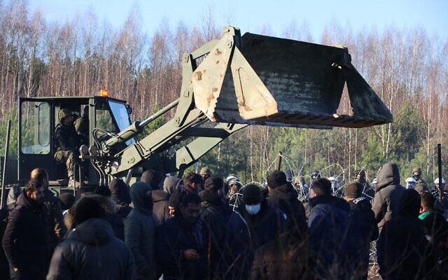 A picture, taken on November 9, 2021, shows migrants at the Belarusian-Polish border in the Grodno region. (Leonid Shcheglov/Belta/AFP)