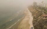 This aerial view shows dust blanketing Netanya on November 13, 2021 (JACK GUEZ / AFP)