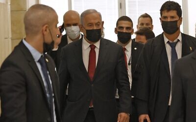 Opposition leader Benjamin Netanyahu arrives for a court hearing in his trial, November 16, 2021, in Jerusalem. (Jack Guez/AFP)
