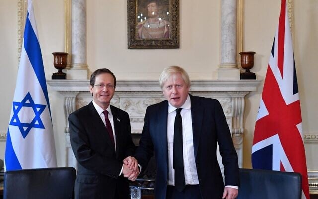 Britain's Prime Minister Boris Johnson (R) shakes hands with Israeli President Isaac Herzog ahead of talks inside Number 10 Downing Street in central London on November 23, 2021 during the Israeli president's three-day visit. (JUSTIN TALLIS / POOL / AFP) Britain's Prime Minister Boris Johnson (R) shakes hands with Israeli President Isaac Herzog ahead of talks inside Number 10 Downing Street in central London on November 23, 2021 during the Israeli president's three-day visit. (JUSTIN TALLIS / POOL / AFP)