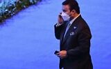 Major General Ahmed Nasser al-Raisi, inspector general at the UAE interior ministry and candidate for the 2021 Interpol election speaks on the phone on the first day of the 89th Interpol General Assembly in Istanbul on November 23, 2021. (Photo by Ozan KOSE / AFP)