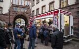People queue in Frankfurt am Main on November 23, 2021, during an event where people in need are offered the vaccination against the novel coronavirus COVID-19 and a meal. (Thomas Lohnes / AFP)