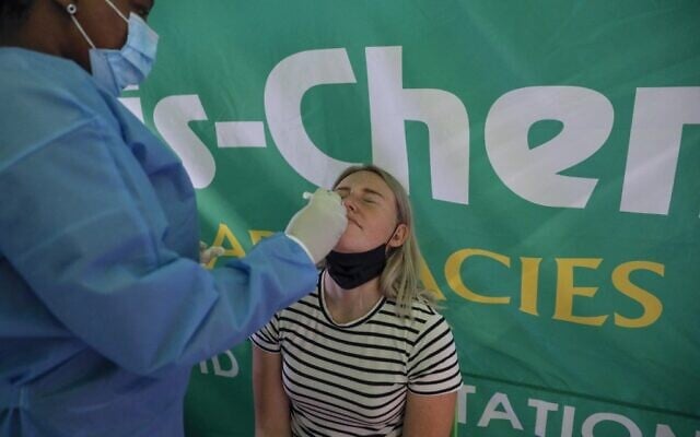 A healthcare worker conducts a polymerase chain reaction (PCR) COVID-19 test on a traveler at OR Tambo International Airport in Johannesburg on November 27, 2021, after several countries banned flights from South Africa following the discovery of a new COVID-19 variant Omicron. (Phill Magakoe / AFP) A healthcare worker conducts a polymerase chain reaction (PCR) COVID-19 test on a traveler at OR Tambo International Airport in Johannesburg on November 27, 2021, after several countries banned flights from South Africa following the discovery of a new COVID-19 variant Omicron. (Phill Magakoe / AFP)