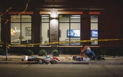 Debris litters the street at a crime scene on November 21, 2021 in Waukesha, Wisconsin. According to reports, an SUV drove through pedestrians at a holiday parade injuring at least 20 people (Jim Vondruska/Getty Images/AFP)
