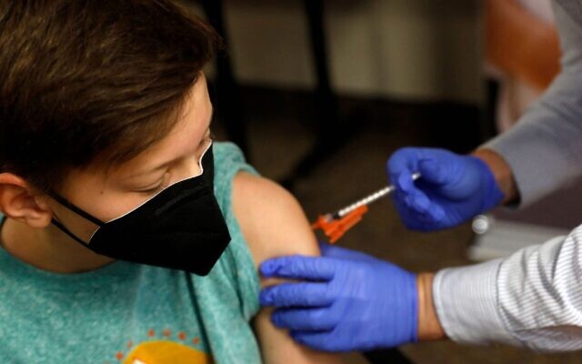Illustrative: Aiden Arthurs receives the Pfizer-BioNTech COVID-19 Vaccine at the Jewish Federation/JARC's offices in Bloomfield Hills, Michigan, May 13, 2021. (Jeff Kowalsky/AFP via Getty Images) Illustrative: Aiden Arthurs receives the Pfizer-BioNTech COVID-19 Vaccine at the Jewish Federation/JARC's offices in Bloomfield Hills, Michigan, May 13, 2021. (Jeff Kowalsky/AFP via Getty Images)