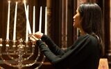 Lakshmi lights a menorah on her visit to New York Central Synagogue during the "Happy Challah Days" episode of her Hulu show, "Taste the Nation." (Craig Blankenhorn/Hulu via JTA)