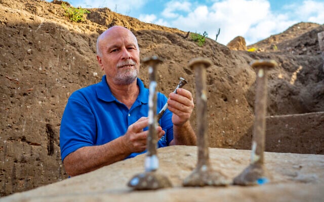 Excavation director Daniel Varga with the glass vials discovered. (Yaniv Berman/Israel Antiquities Authority) Excavation director Daniel Varga with the glass vials discovered. (Yaniv Berman/Israel Antiquities Authority)