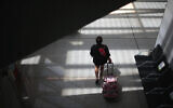 Illustrative: A passenger walks at Son Sant Joan airport on the Spanish Balearic Island of Mallorca, Spain, Monday, July 27, 2020. (AP Photo/Joan Mateu)