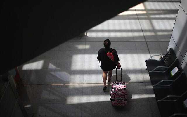 Illustrative: A passenger walks at Son Sant Joan airport on the Spanish Balearic Island of Mallorca, Spain, Monday, July 27, 2020. (AP Photo/Joan Mateu) Illustrative: A passenger walks at Son Sant Joan airport on the Spanish Balearic Island of Mallorca, Spain, Monday, July 27, 2020. (AP Photo/Joan Mateu)