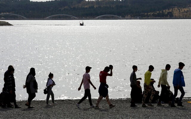 A boat moves on the Persian Gulf Martyrs' Lake as people walk on the shore of the lake, in western Tehran, Iran, Nov. 5, 2020 (AP Photo/Vahid Salemi) A boat moves on the Persian Gulf Martyrs' Lake as people walk on the shore of the lake, in western Tehran, Iran, Nov. 5, 2020 (AP Photo/Vahid Salemi)
