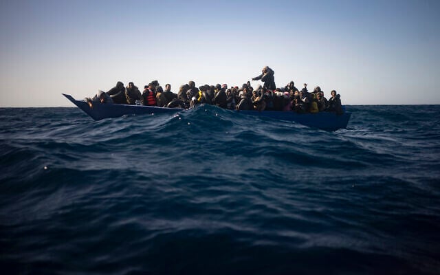 Illustrative: Migrants from Eritrea, Egypt, Syria and Sudan, wait to be assisted by aid workers of the Spanish NGO Open Arms, after fleeing Libya on board a precarious wooden boat in the Mediterranean sea, about 110 miles north of Libya, on January 2, 2021. (AP Photo/Joan Mateu) Illustrative: Migrants from Eritrea, Egypt, Syria and Sudan, wait to be assisted by aid workers of the Spanish NGO Open Arms, after fleeing Libya on board a precarious wooden boat in the Mediterranean sea, about 110 miles north of Libya, on January 2, 2021. (AP Photo/Joan Mateu)