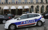A police car drives past the Ritz hotel in Paris, April 15, 2020. (Michel Euler/AP)