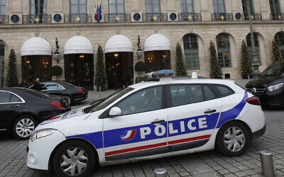 A police car drives past the Ritz hotel in Paris, April 15, 2020. (Michel Euler/AP)