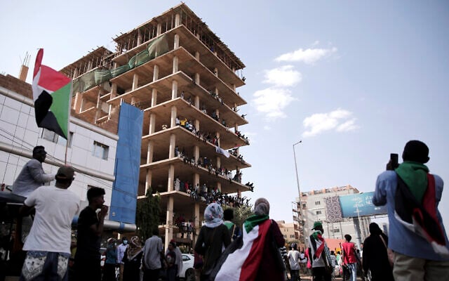 People chant slogans inside a building under construction during a protest in Khartoum, Sudan, Saturday, Oct. 30, 2021. Pro-democracy groups called for mass protest marches across the country Saturday to press demands for re-instating a deposed transitional government and releasing senior political figures from detention. (AP Photo/Marwan Ali) People chant slogans inside a building under construction during a protest in Khartoum, Sudan, Saturday, Oct. 30, 2021. Pro-democracy groups called for mass protest marches across the country Saturday to press demands for re-instating a deposed transitional government and releasing senior political figures from detention. (AP Photo/Marwan Ali)