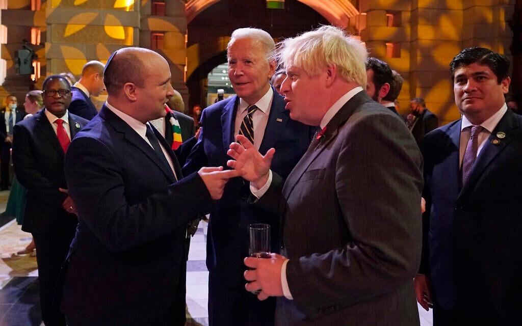 Prime Minister Naftali Bennett, US President Joe Biden and British Prime Minister Boris Johnson chat as they attend an evening reception to mark the opening day of the COP26 UN Climate Summit, in Glasgow, Scotland, on Monday, November 1, 2021. (AP Photo/Alberto Pezzali, Pool) Prime Minister Naftali Bennett, US President Joe Biden and British Prime Minister Boris Johnson chat as they attend an evening reception to mark the opening day of the COP26 UN Climate Summit, in Glasgow, Scotland, on Monday, November 1, 2021. (AP Photo/Alberto Pezzali, Pool)