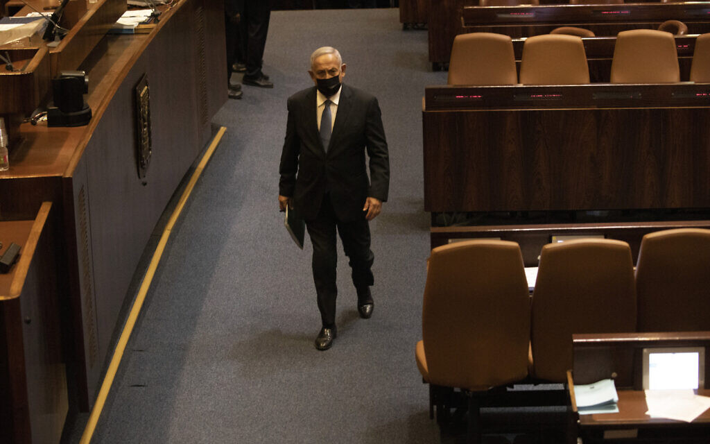 Former prime minister Benjamin Netanyahu walks during a session of the Knesset in Jerusalem, October 4, 2021. (AP Photo/Ariel Schalit, File) Former prime minister Benjamin Netanyahu walks during a session of the Knesset in Jerusalem, October 4, 2021. (AP Photo/Ariel Schalit, File)