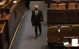 Former prime minister Benjamin Netanyahu walks during a session of the Knesset in Jerusalem, October 4, 2021. (AP Photo/Ariel Schalit, File)