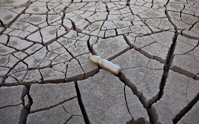 An empty plastic bottle is seen in a crack of mud at the Shlomo River, near Eilat, Israel, November 3, 2021. (AP Photo/Oded Balilty) An empty plastic bottle is seen in a crack of mud at the Shlomo River, near Eilat, Israel, November 3, 2021. (AP Photo/Oded Balilty)