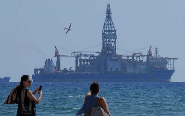 People take photos of the 'Tungsten Explored' drilling ship, in the southern coastal city of Larnaca, Cyprus, November 3, 2021. (AP Photo/ Petros Karadjias)