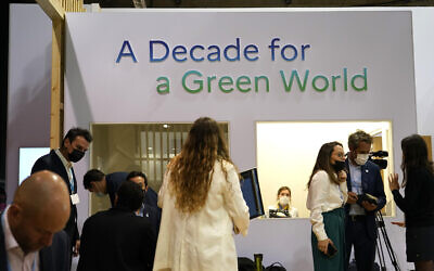 People gather in the French pavilion inside the venue of the COP26 UN Climate Summit in Glasgow, Scotland, November 2, 2021. (Alberto Pezzali/AP)