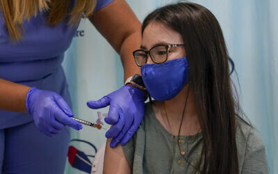 RN Rosemary Lantigua inoculates Ryann Onofrio Franceschini, 11, with the first dose of the Pfizer-BioNTech COVID-19 vaccine for children five to 12 years at The Children's Hospital at Montefiore, November 3, 2021, in the Bronx borough of New York. (AP Photo/Mary Altaffer)