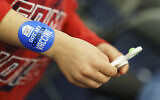 A five-year-old boy wears a sticker on his arm after receiving the Pfizer COVID-19 vaccine for children ages 5-11 at a state-run site in Cranston, Rhode Island, November 4, 2021. (David Goldman/AP)