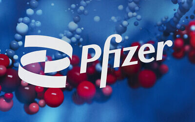 This Feb. 5, 2021, file photo shows the Pfizer logo displayed at the company's headquarters in New York.  Pfizer says its experimental pill for COVID-19 cut rates of hospitalization and death by nearly 90% among patients with mild-to-moderate infections. (AP Photo/Mark Lennihan, File)
