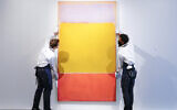 Art handlers adjust Mark Rothko's 'No. 7' on display at Sotheby's auction house during a press preview for the upcoming The Macklowe Collection auction, Nov. 5, 2021, in New York. (AP Photo/Mary Altaffer)