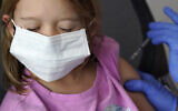 Illustrative: A girl, 6, receives the Pfizer COVID-19 vaccine for children 5 to 11 at Lurie Children's hospital in Chicago, November 5, 2021. (Nam Y. Huh/AP)