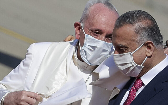 Pope Francis is greeted by Iraqi Prime Minister Mustafa al-Kadhimi as he arrives at Baghdad's international airport, Iraq, on March 5, 2021. (AP Photo/Andrew Medichini)