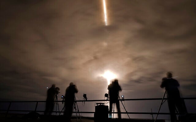 Photographers are silhouetted as a SpaceX Falcon 9 rocket with the Crew Dragon attached lifts off on November 10, 2021, at the Kennedy Space Center in Cape Canaveral, Florida. (AP Photo/Chris O'Meara) Photographers are silhouetted as a SpaceX Falcon 9 rocket with the Crew Dragon attached lifts off on November 10, 2021, at the Kennedy Space Center in Cape Canaveral, Florida. (AP Photo/Chris O'Meara)