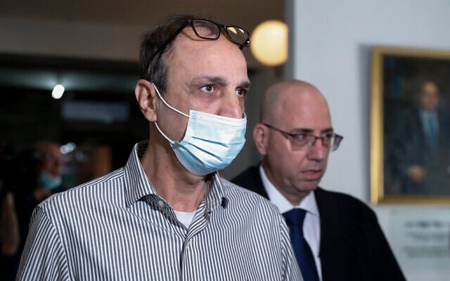 Shmuel Peleg, grandfather of Eitan Biran, who survived a cable car crash in Italy that killed his immediate family, arrives at court in Tel Aviv, on Thursday, November 11, 2021. (AP Photo/Ariel Schalit)