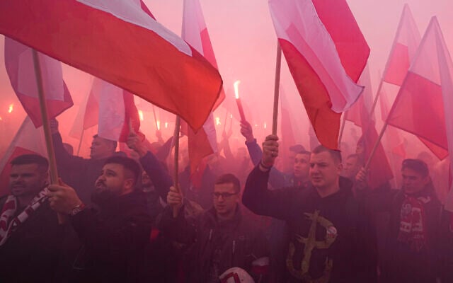 Members of far-right groups light flares as they try to dominate the annual Independence Day march in Warsaw, Poland, on November 11, 2021. (AP Photo/Czarek Sokolowski) Members of far-right groups light flares as they try to dominate the annual Independence Day march in Warsaw, Poland, on November 11, 2021. (AP Photo/Czarek Sokolowski)