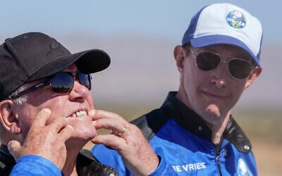 FILE - Glen de Vries, right, takes a look as William Shatner, left, shows what rocket lift off did to his face during a media availability at the spaceport near Van Horn, Texas, Oct. 13, 2021 (AP Photo/LM Otero, File)