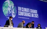 Alok Sharma, center  seated, President of the COP26 summit attends a stocktaking plenary session at the COP26 UN Climate Summit, in Glasgow, Scotland, Saturday, Nov. 13, 2021 (AP Photo/Alberto Pezzali)