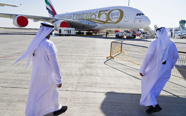 Two Emiratis walk toward an Emirates Airbus A380 jumbo jet on display at the Dubai Air Show in Dubai, United Arab Emirates, November 14, 2021. (AP Photo/Jon Gambrell) Two Emiratis walk toward an Emirates Airbus A380 jumbo jet on display at the Dubai Air Show in Dubai, United Arab Emirates, November 14, 2021. (AP Photo/Jon Gambrell)