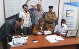 Seif al-Islam, center, the son and one-time heir apparent of late Libyan dictator Muammar Gaddafi, registers his candidacy for the country’s presidential elections, in Sabha, Libya, November 14, 2021. (Libyan High National Elections Commission via AP)