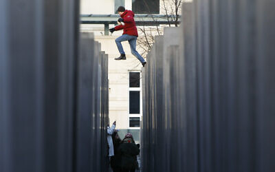 Illustrative: A man jumps between columns as part of the 2711 concrete slabs of the Holocaust Memorial on the international Holocaust remembrance day in Berlin, Germany, January 27, 2011. (Markus Schreiber/AP)