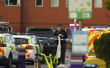 Emergency services outside Liverpool Women's Hospital in Liverpool, England, Sunday, Nov. 14, 2021. (Peter Byrne/PA via AP)