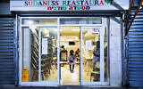 A Sudanese migrant family are seen in a closed Sudanese restaurant in south Tel Aviv, on October 27, 2020. (AP Photo/Oded Balilty, File)