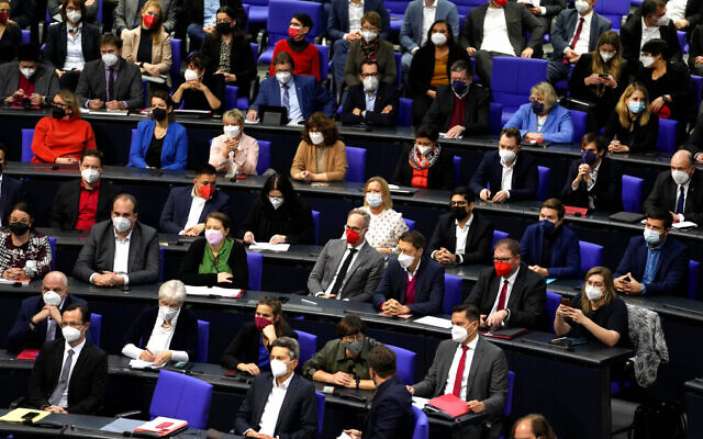 German lawmakers wear face mask as they attend a Bundestag session about new measures to battle the coronavirus pandemic at the Reichstag building in Berlin, Germany, November 18, 2021. (AP Photo/Markus Schreiber) German lawmakers wear face mask as they attend a Bundestag session about new measures to battle the coronavirus pandemic at the Reichstag building in Berlin, Germany, November 18, 2021. (AP Photo/Markus Schreiber)