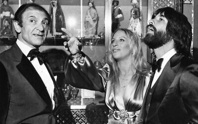 Iran's then-Ambassador Ardeshir Zahedi, left, talks with actress Barbra Streisand and her escort Jon Peters as they admire the Iranian Embassy March 8, 1975 during a reception in Washington, D.C. (AP Photo/Charles W. Harrity, File)