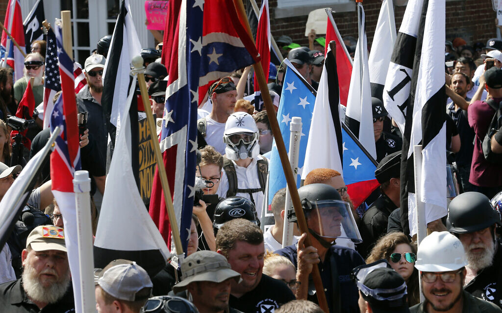 White nationalist demonstrators walk into the entrance of Lee Park surrounded by counter demonstrators in Charlottesville, VA, on Saturday, August 12, 2017. (AP Photo/Steve Helber) White nationalist demonstrators walk into the entrance of Lee Park surrounded by counter demonstrators in Charlottesville, VA, on Saturday, August 12, 2017. (AP Photo/Steve Helber)