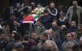 Palestinians carry the body of Isra Khazimia who was killed by Israeli fire after allegedly trying to stab an officer in Jerusalem's Old City in September, during her funeral in the West Bank village of Qabatiya, Saturday, Nov. 20, 2021.(AP Photo/Majdi Mohammed)